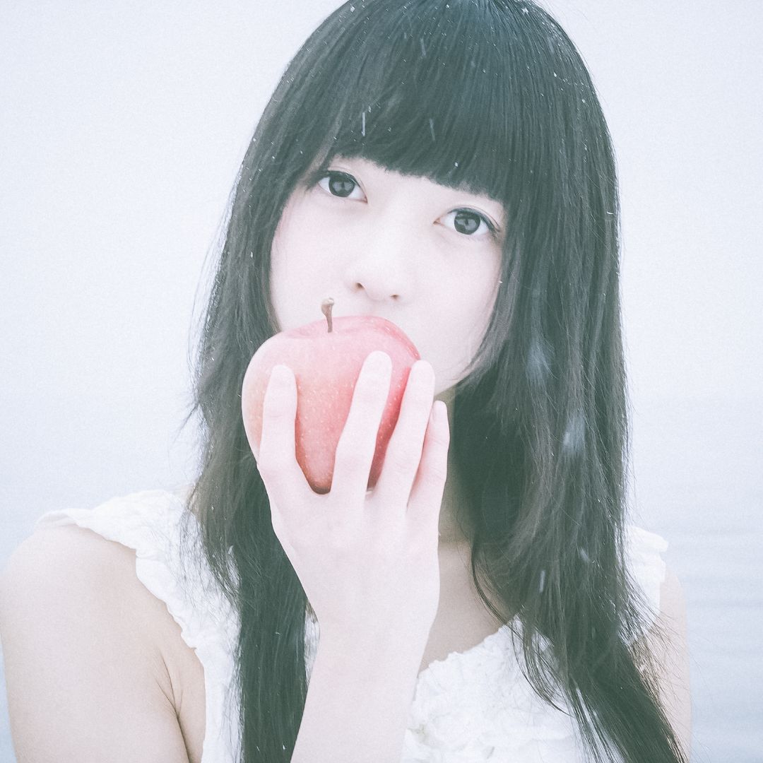 A woman biting an apple